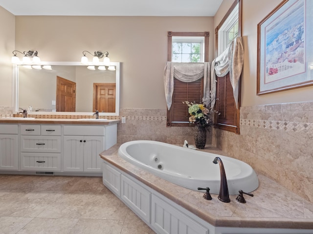 4424 Donway Dr NE, Alexandria, MN 56308 - bathroom featuring double vanity, a whirlpool tub, tile walls, and a wainscoted wall