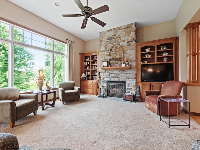 4424 Donway Dr NE, Alexandria, MN 56308 - living room featuring a ceiling fan, a stone fireplace, and carpet floors