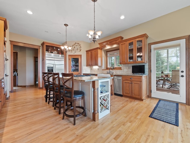 4424 Donway Dr NE, Alexandria, MN 56308 - kitchen with brown cabinetry, light wood finished floors, stainless steel appliances, and recessed lighting