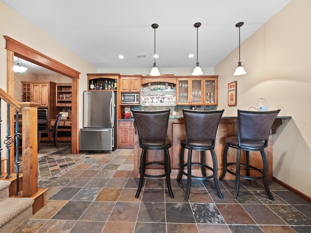 4424 Donway Dr NE, Alexandria, MN 56308 - indoor wet bar featuring stainless steel appliances, stairway, stone tile flooring, and recessed lighting