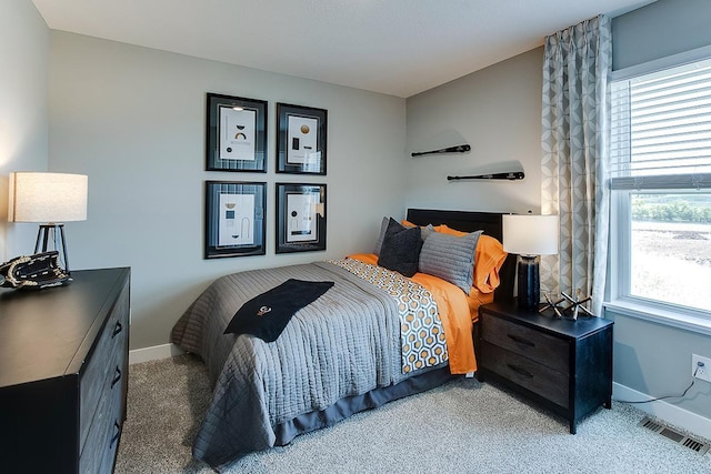 carpeted bedroom featuring multiple windows