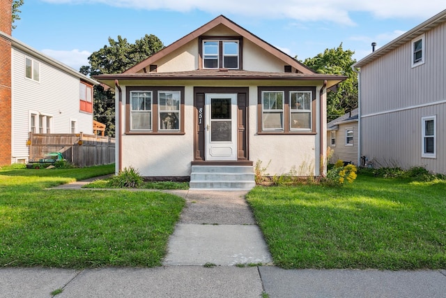 bungalow-style home featuring a front yard