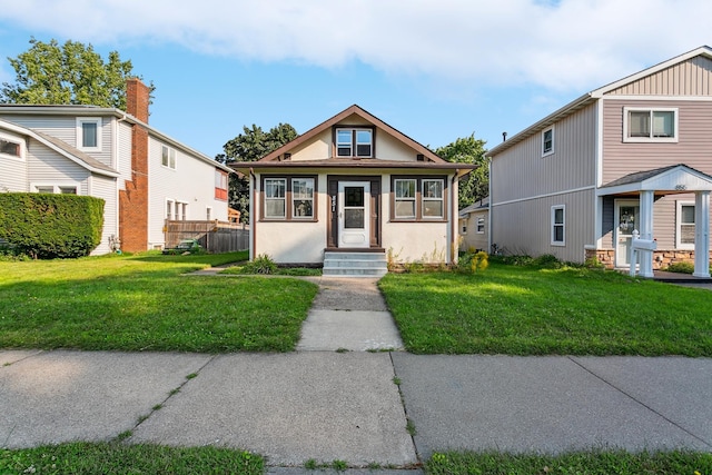 bungalow-style house with a front lawn