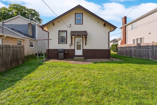 back of house with a lawn