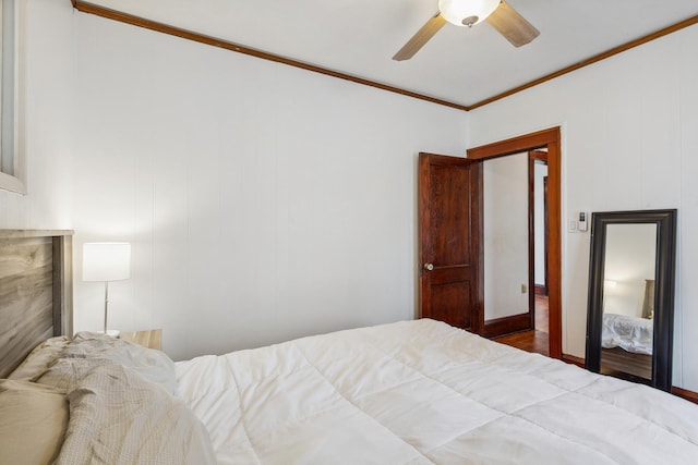 bedroom featuring ceiling fan, hardwood / wood-style flooring, and ornamental molding