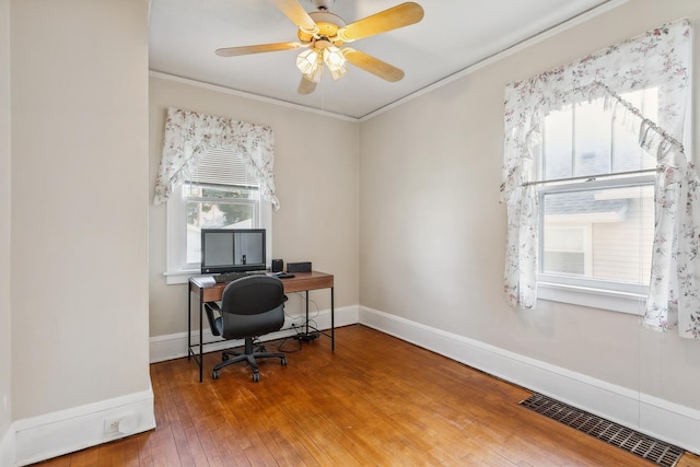 office with ceiling fan, hardwood / wood-style flooring, and ornamental molding