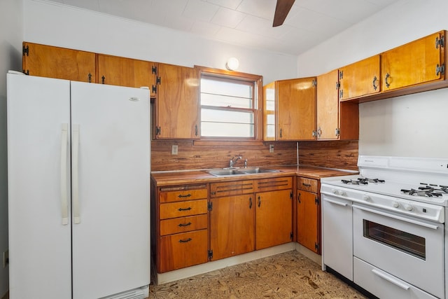 kitchen with ceiling fan, sink, white appliances, and tasteful backsplash