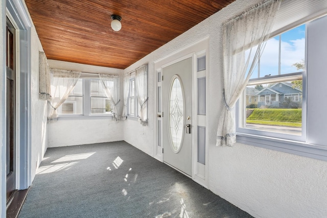 foyer with carpet flooring and wooden ceiling