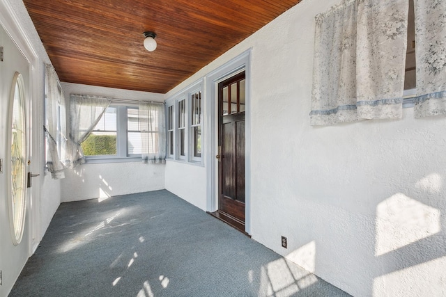 unfurnished sunroom featuring wood ceiling