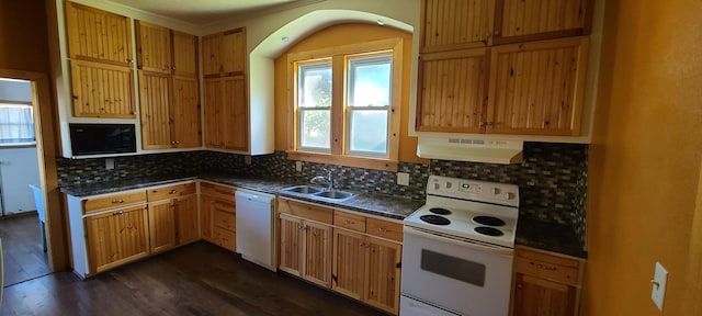 kitchen featuring decorative backsplash, dark wood-type flooring, sink, and white appliances