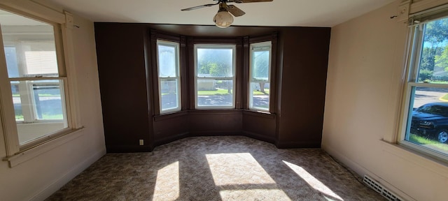 empty room featuring ceiling fan and carpet floors