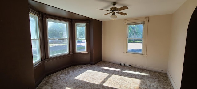 carpeted empty room featuring ceiling fan