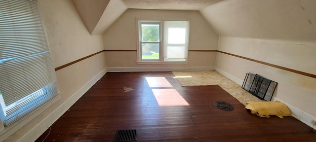 bonus room featuring wood-type flooring and vaulted ceiling