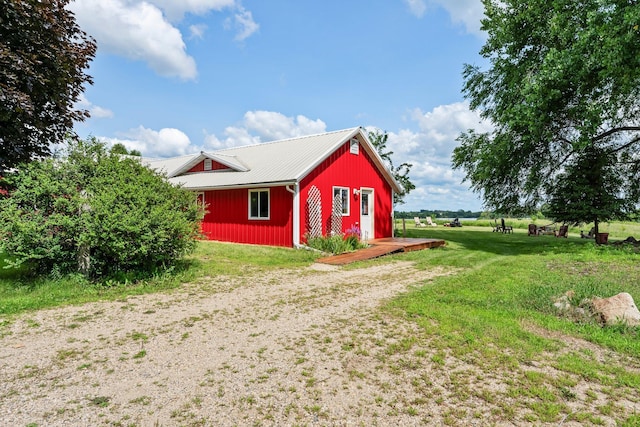 view of outdoor structure with a yard and a rural view