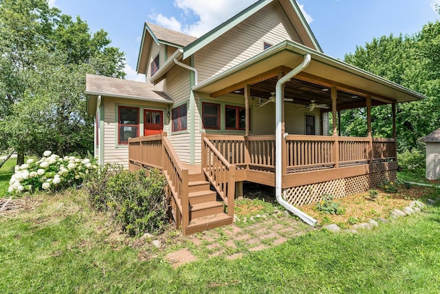 back of house featuring a wooden deck and ceiling fan