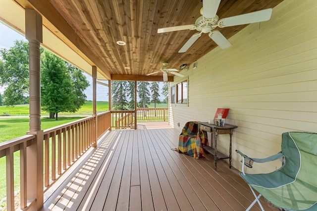 deck featuring a lawn and ceiling fan