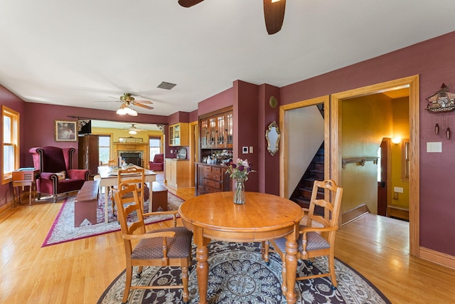 dining room with light wood-type flooring and ceiling fan