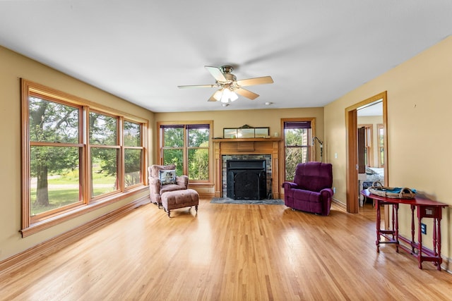 living room with ceiling fan and light hardwood / wood-style floors