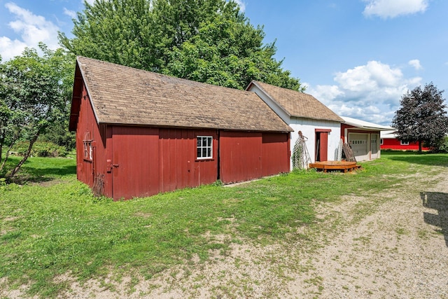 view of outdoor structure featuring a lawn