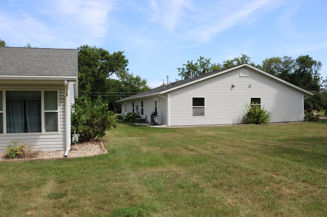 view of side of home with a lawn