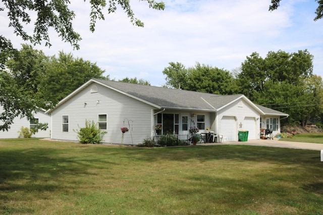 ranch-style home featuring a porch, a garage, and a front yard