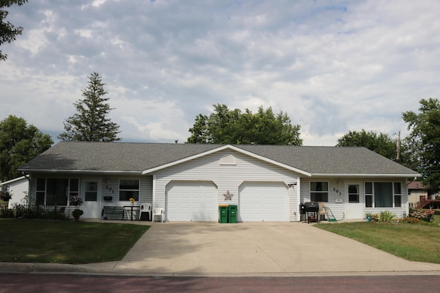 ranch-style home with a front yard, roof with shingles, a garage, and driveway