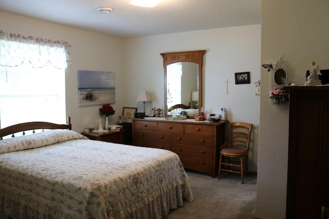 carpeted bedroom featuring a textured ceiling