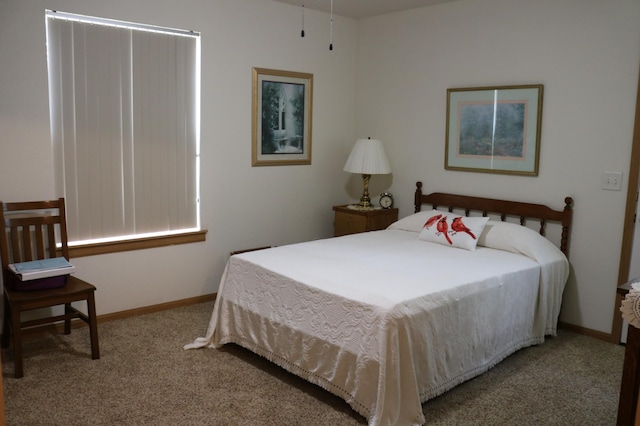 bedroom featuring carpet and baseboards