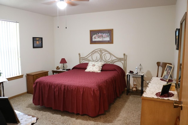 bedroom with light colored carpet, baseboards, and a ceiling fan