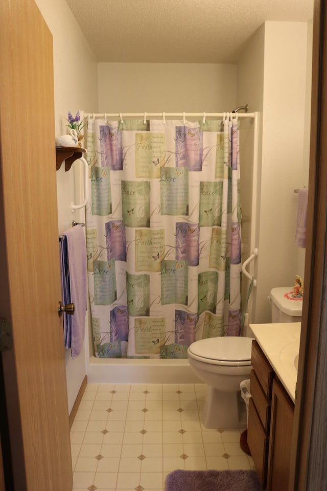 bathroom featuring vanity, toilet, a textured ceiling, tile patterned flooring, and a shower with shower curtain