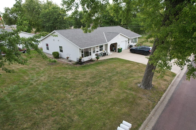 single story home featuring concrete driveway, a garage, roof with shingles, and a front yard