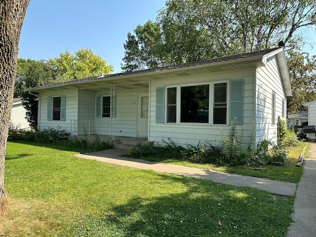 ranch-style home with a front lawn