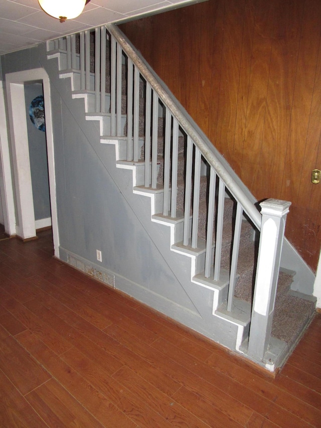 stairs with hardwood / wood-style floors