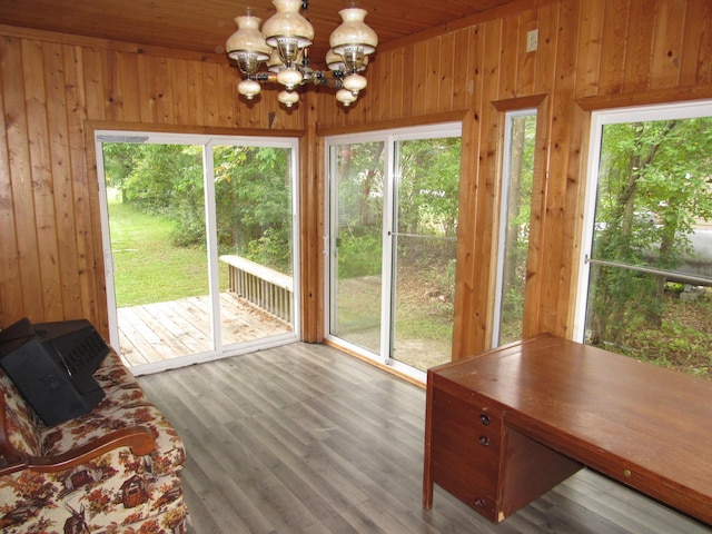 unfurnished sunroom featuring an inviting chandelier and wooden ceiling