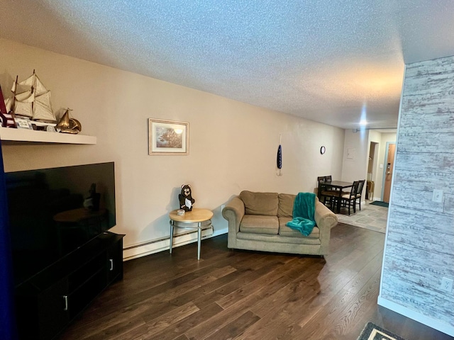 living room featuring dark wood-type flooring, a baseboard heating unit, and a textured ceiling