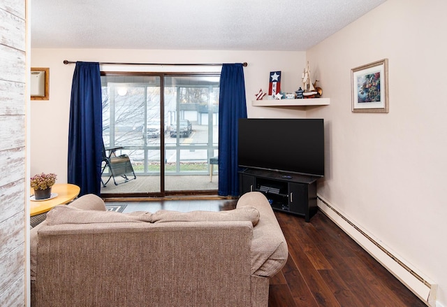 living room featuring a baseboard heating unit, dark hardwood / wood-style flooring, and a textured ceiling