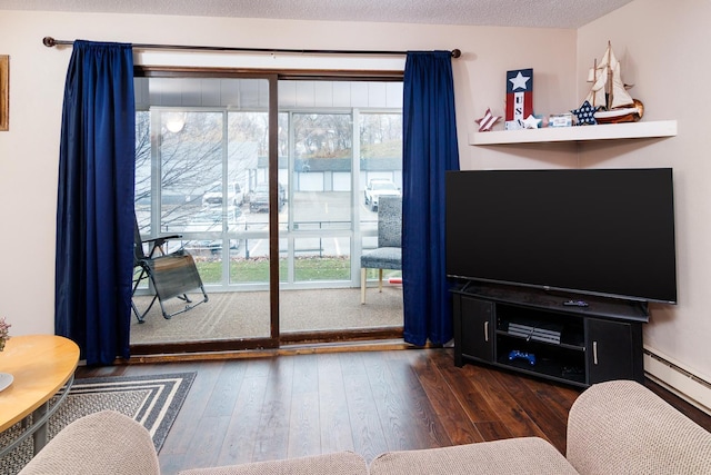 living room with a textured ceiling, dark wood-type flooring, and a baseboard radiator