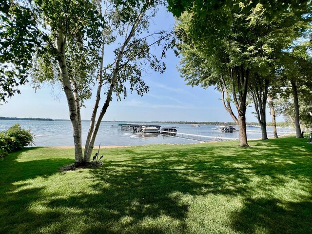 exterior space with a water view and a lawn