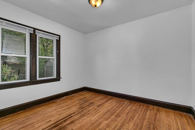 unfurnished room with hardwood / wood-style floors