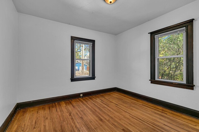 empty room with hardwood / wood-style flooring