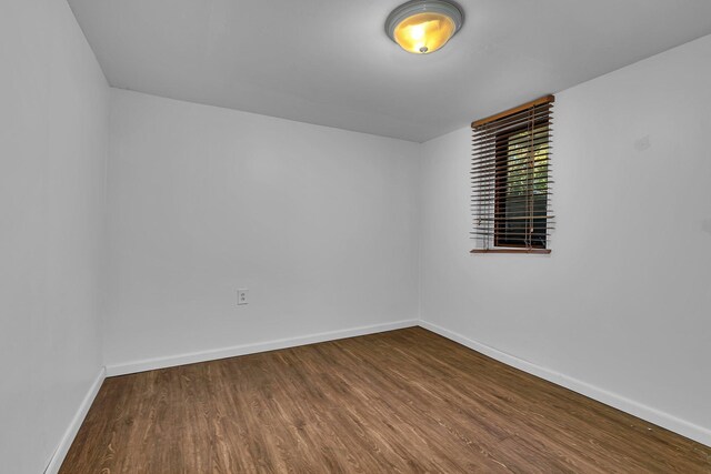 spare room featuring wood-type flooring