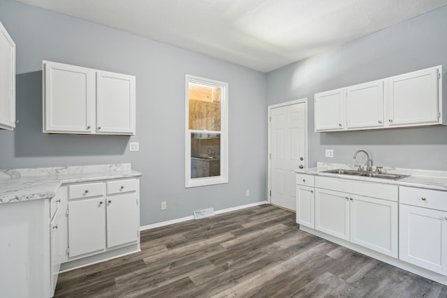 kitchen with white cabinetry, dark hardwood / wood-style flooring, sink, and a textured ceiling