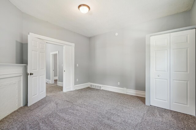 unfurnished bedroom featuring a closet and carpet