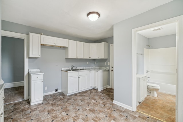 kitchen with sink and white cabinetry