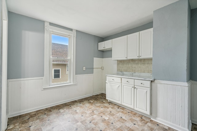 kitchen with white cabinets and decorative backsplash