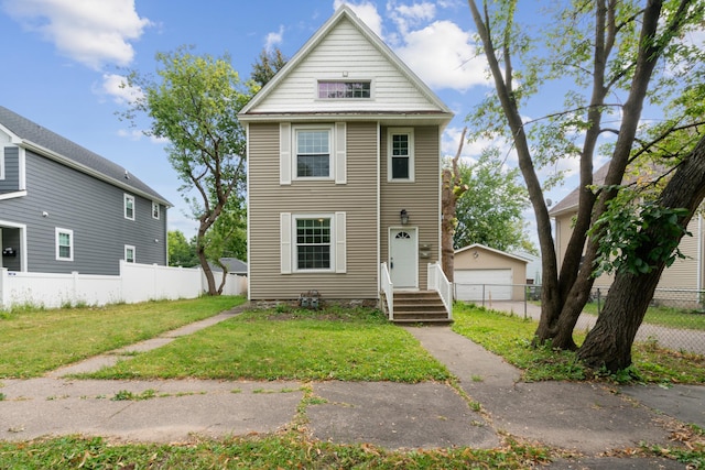 front of property featuring a garage, an outdoor structure, and a front yard