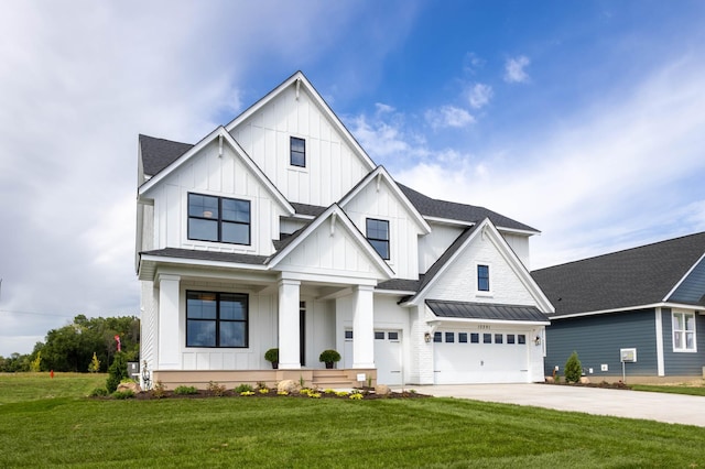 modern farmhouse with a front yard and a garage