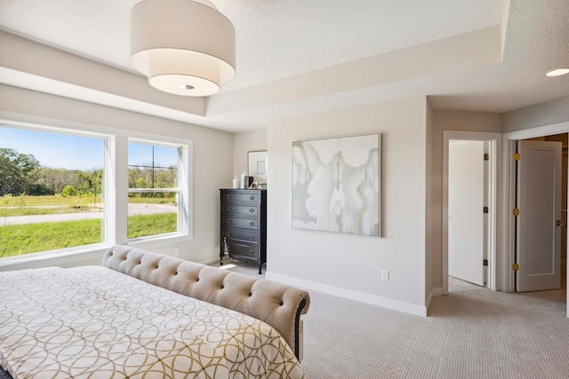 bedroom with a textured ceiling and light colored carpet