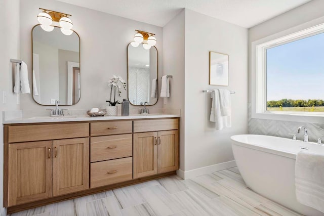 bathroom featuring vanity and a bath