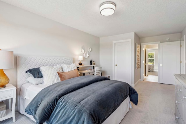 carpeted bedroom with a textured ceiling